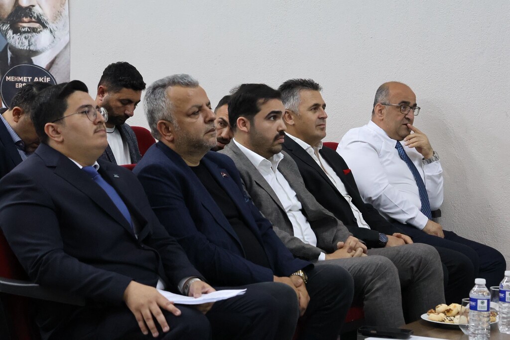 TÜGVA Çiğli Genel Kurulu'nda Anılcan Çiçek, AK Parti Çiğli İlçe Başkanı Oktay Özdemir ve Çiğli Milli Eğitim Müdürü Şüayip Üner bir arada protokol koltuklarında otururken.